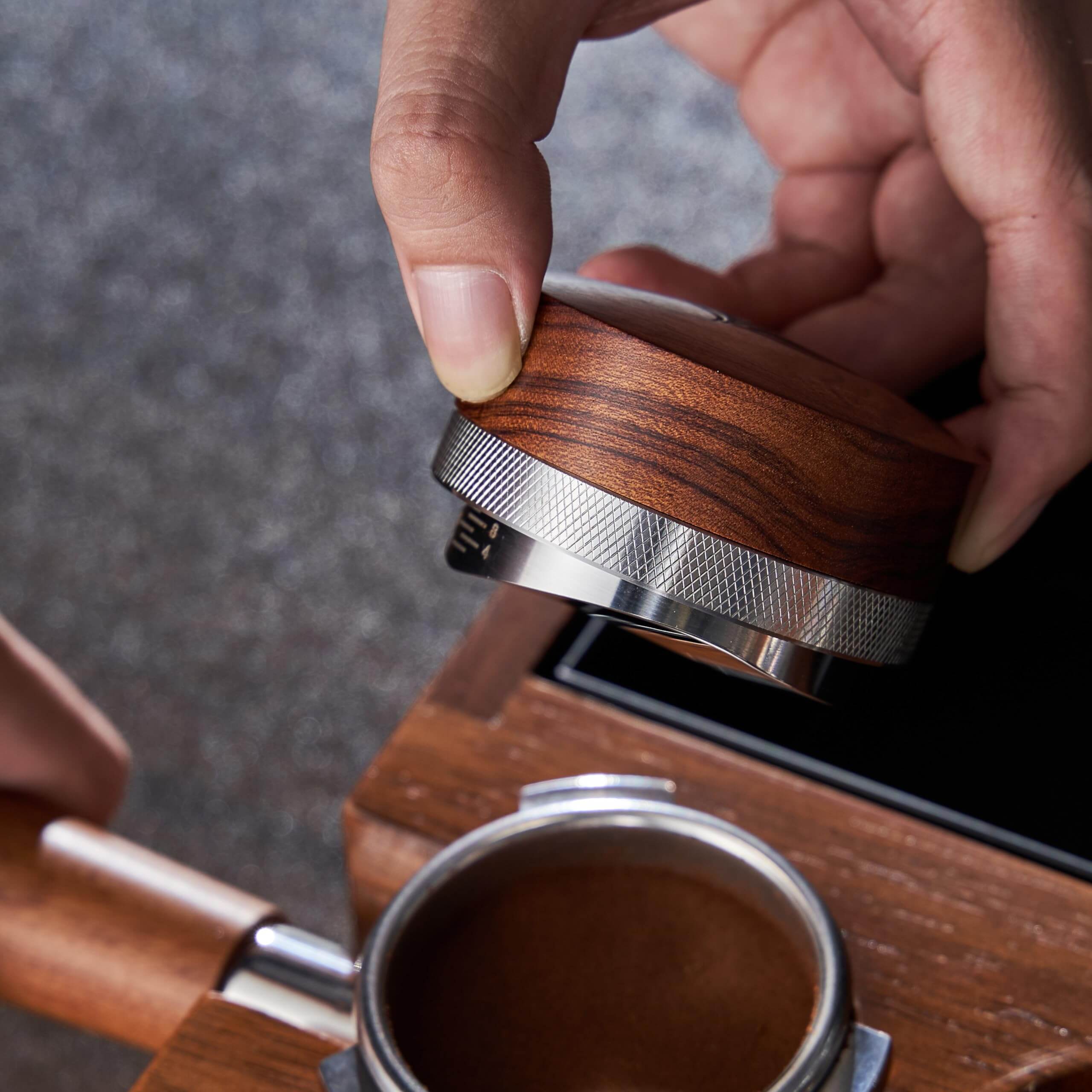 KNODOS 58mm espresso precision tool showing the adjustable distributor base in a professional black finish.