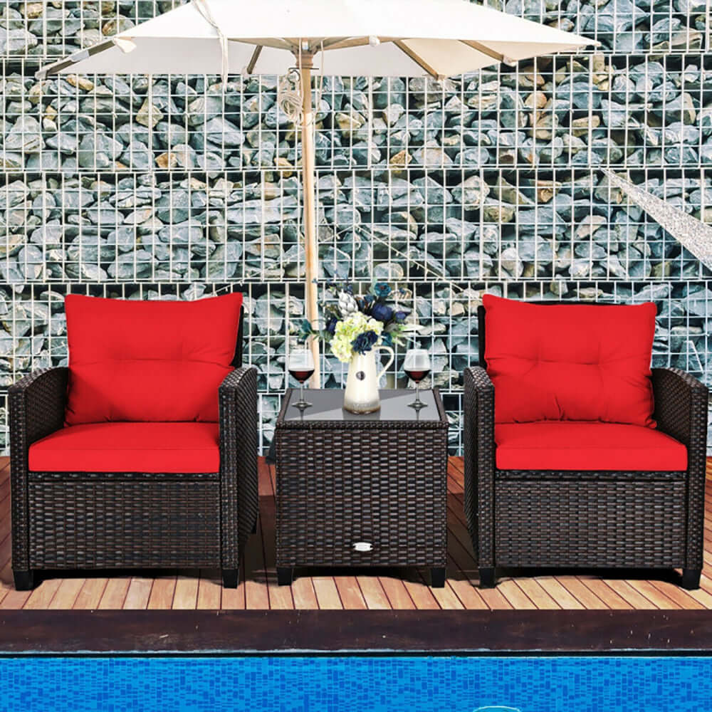 3-piece rattan outdoor bistro set featuring two ergonomic chairs with red cushions and a tempered glass coffee table by the pool