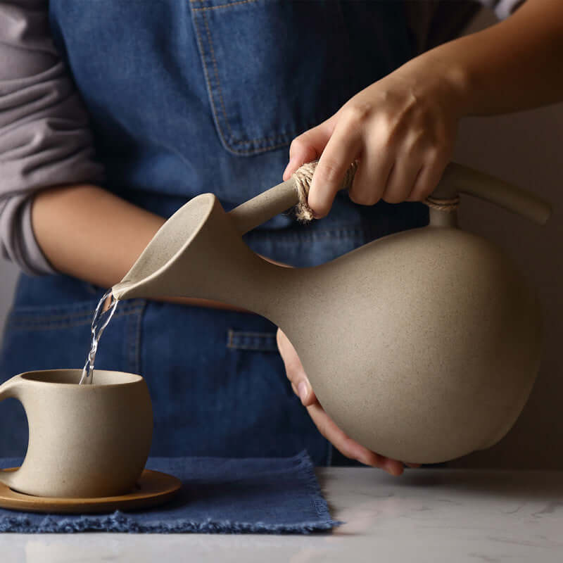 Nordic style pottery pitcher serving fresh cold water in a minimalist kitchen