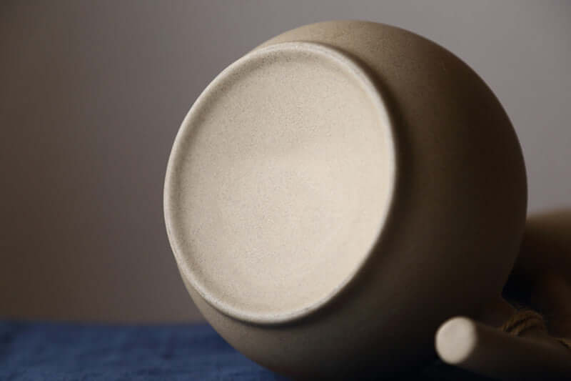 Bottom view of a handcrafted ceramic kettle showcasing its minimalist design and eco-friendly materials.