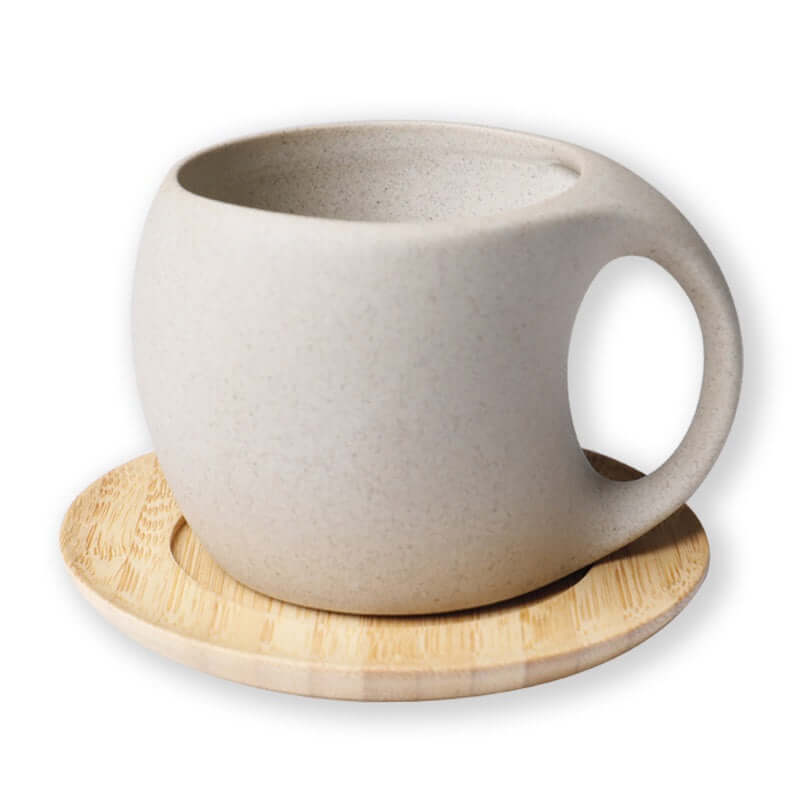 Handcrafted ceramic kettle with bamboo tray, perfect for serving cold beverages in a minimalist Nordic style.