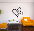 Romantic wall decal featuring a floral heart design and the word 'love' in a stylish living room setting.