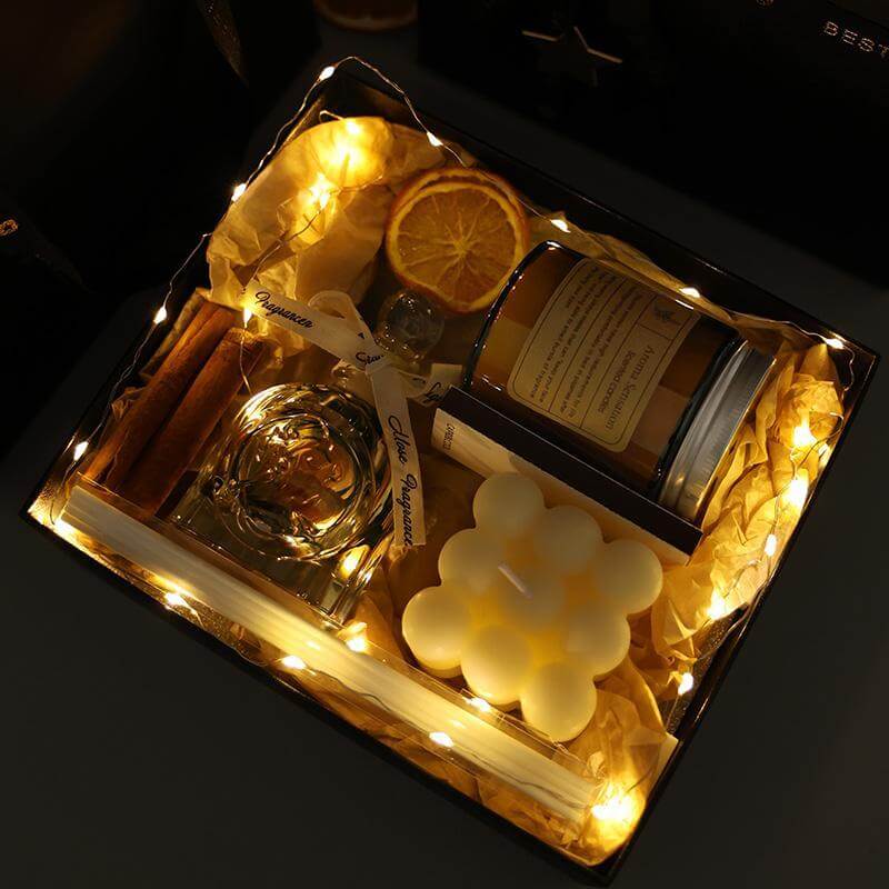 Luxury aromatherapy candle and oil gift set in an elegant box with lights and delicate fragrances for relaxation.