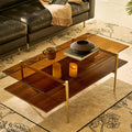 Elegant living room setup featuring the gold and glass coffee table as a centerpiece on a designer rug.