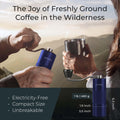 Portable hand-crank coffee grinder being used at a forest campsite for fresh brewing