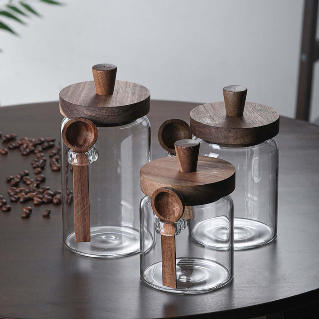 Clear glass kitchen canisters with integrated wooden spoon holders
