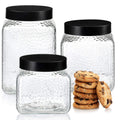 Set of 3 retro glass canisters with vertical ribbing and black metal lids