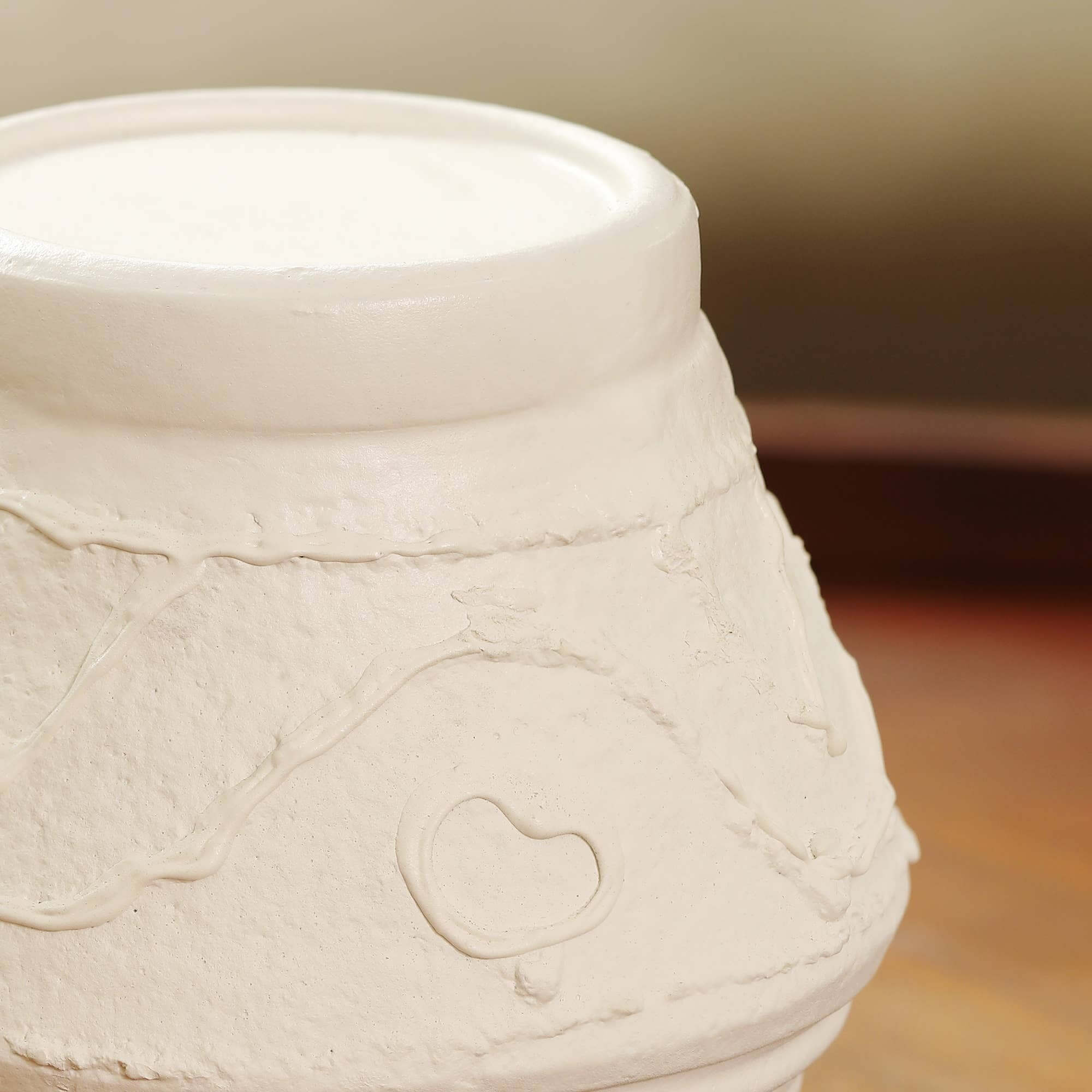 Detailed organic textured pattern on handmade terracotta candle stand