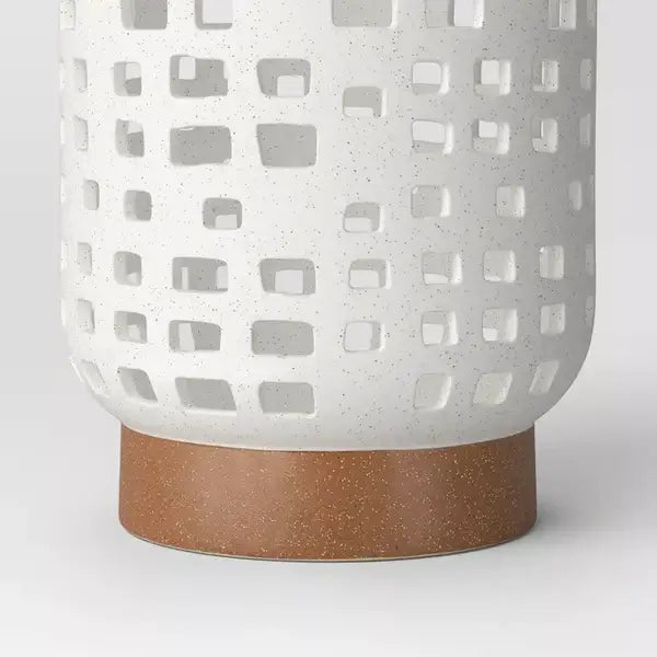 Speckled finish detail on a white ceramic lantern candle holder