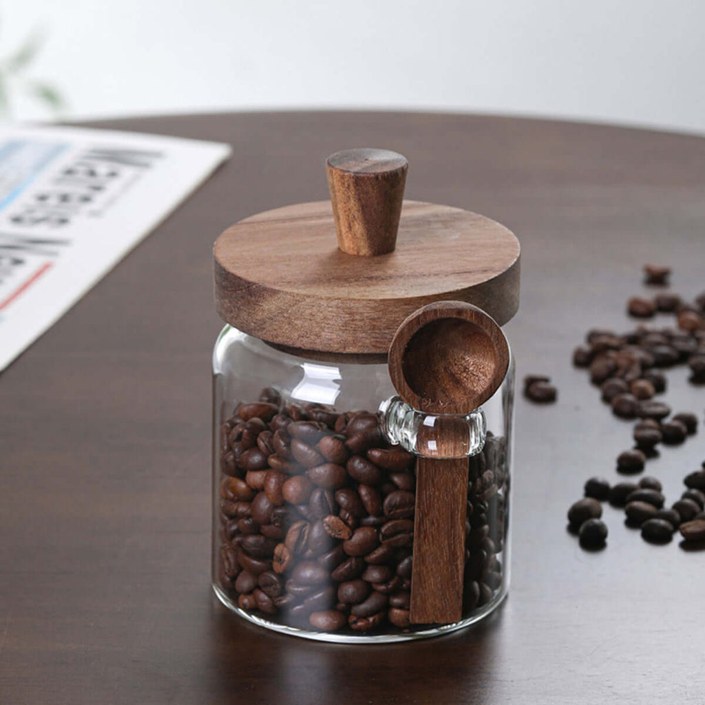 Close-up of integrated wooden spoon holder on a clear glass canister