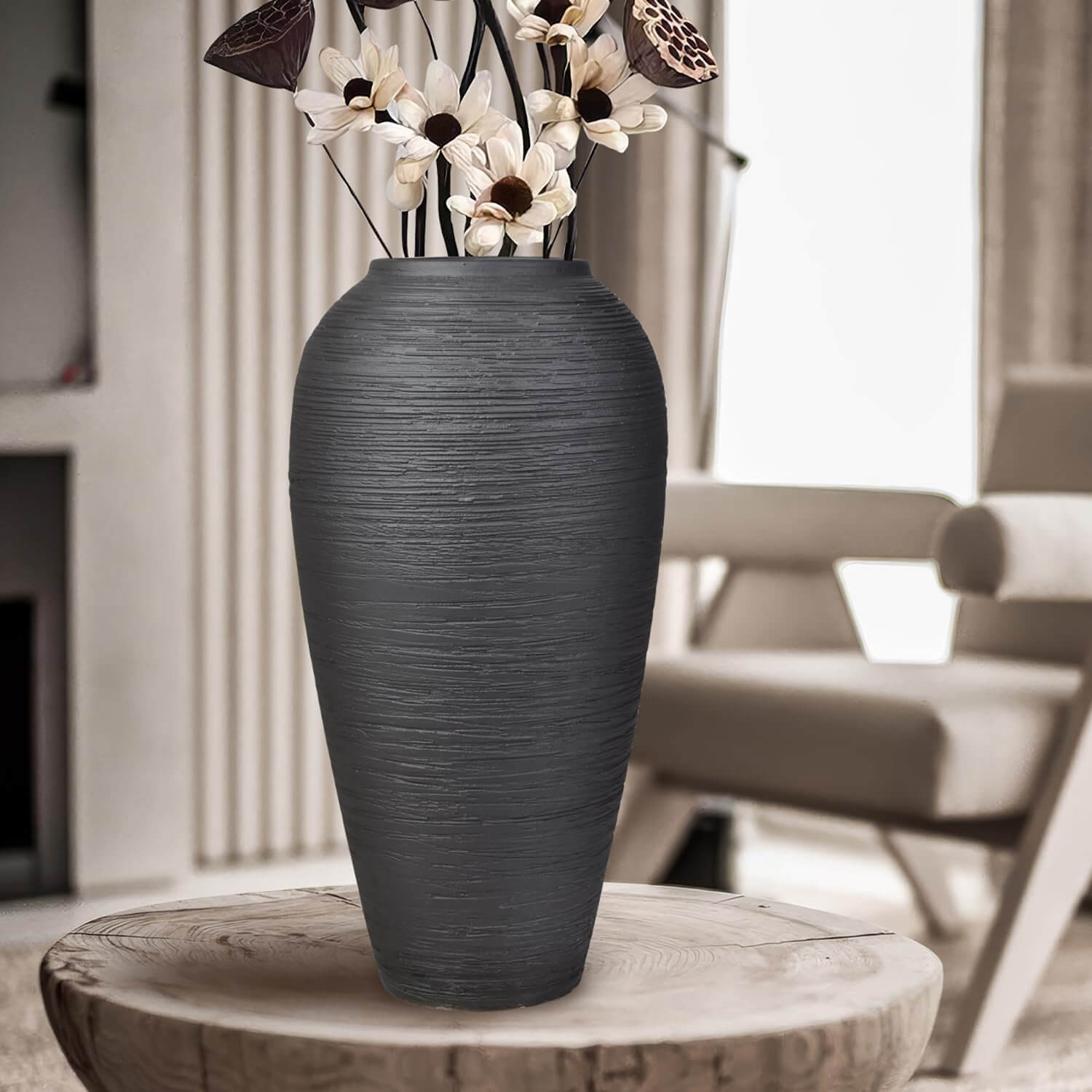 Modern bohemian living room decor with large black ceramic vase on an entryway table