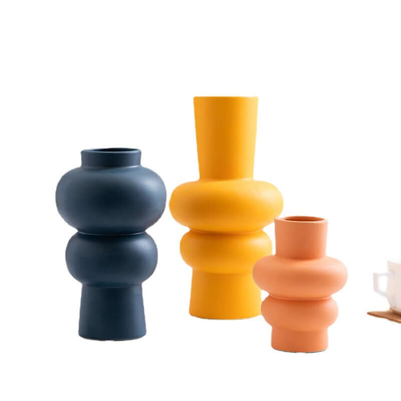 Nordic Minimalist Ceramic Vase set featuring geometric designs, perfect for home decor and floral arrangements.