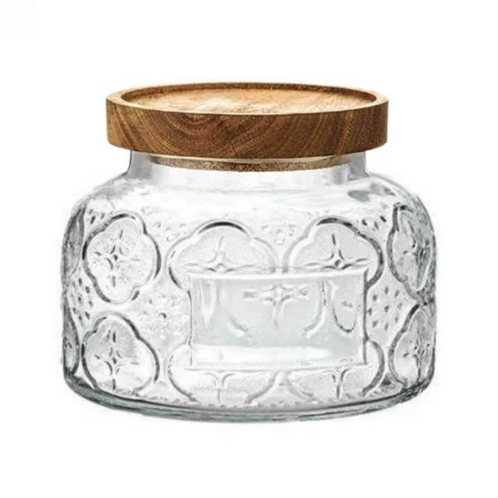 Vintage embossed glass storage jar with a Begonia flower pattern and airtight lid for kitchen organization.