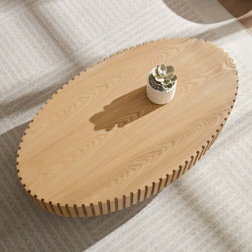Sturdy drum-style pedestal base of the oval wooden coffee table for modern interiors.