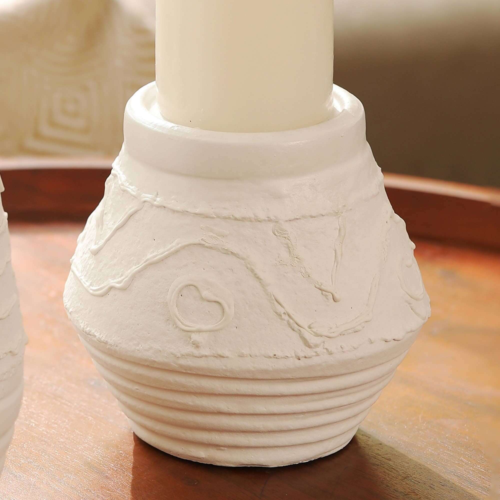 Rustic terracotta candle holder with unique organic pattern for ambient lighting, ideal for home decoration.